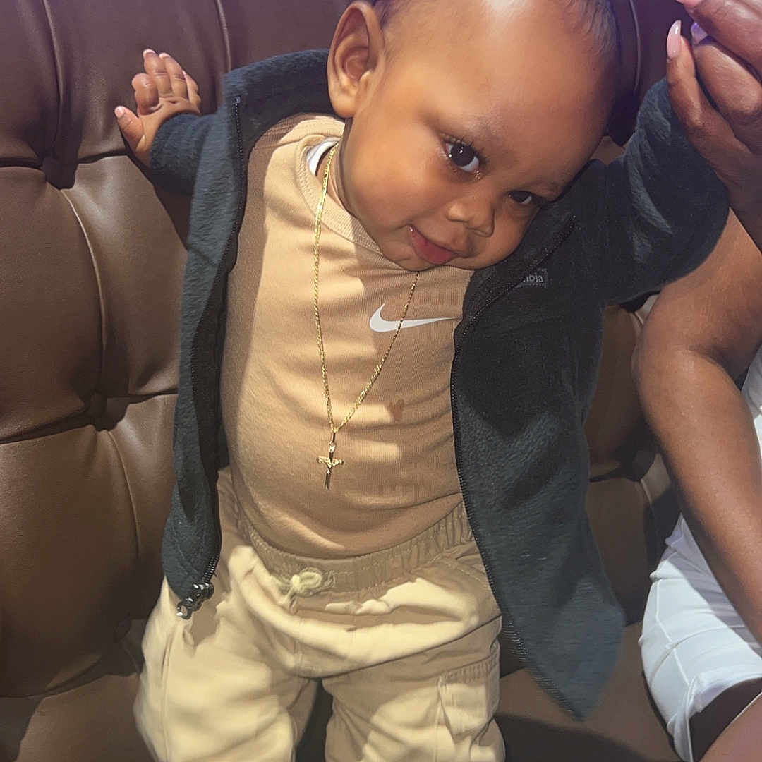 Nasir-Amir joined the competition — help win amazing prizes! accessories, baby, bodypart, clothing, couch, face, finger, footwear, furniture, hand, head, jewelry, necklace, pants, person, photography, portrait, shoe, sitting, sneaker