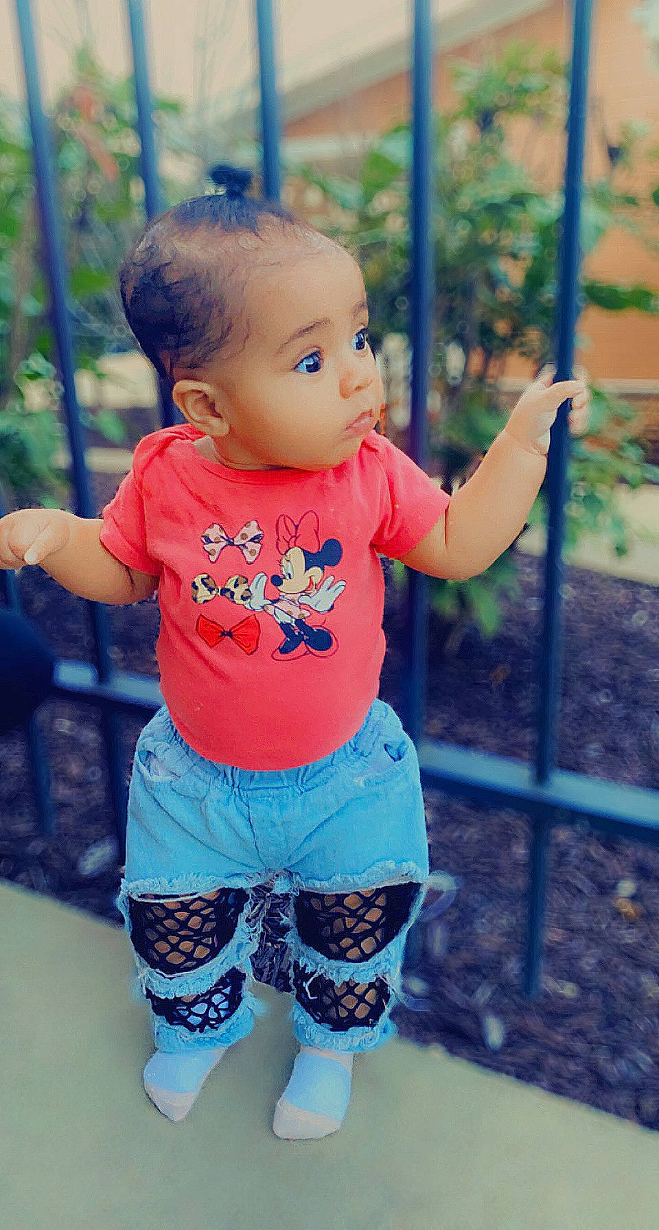 Isabella is registered to the contest to win money with this photo: azure, baby_toddler_clothing, clothing, eye, face, facial_expression, happy, head, joint, people_in_nature, person, pink, plant, shorts, shoulder, skin, sleeve, standing, t_shirt, toddler