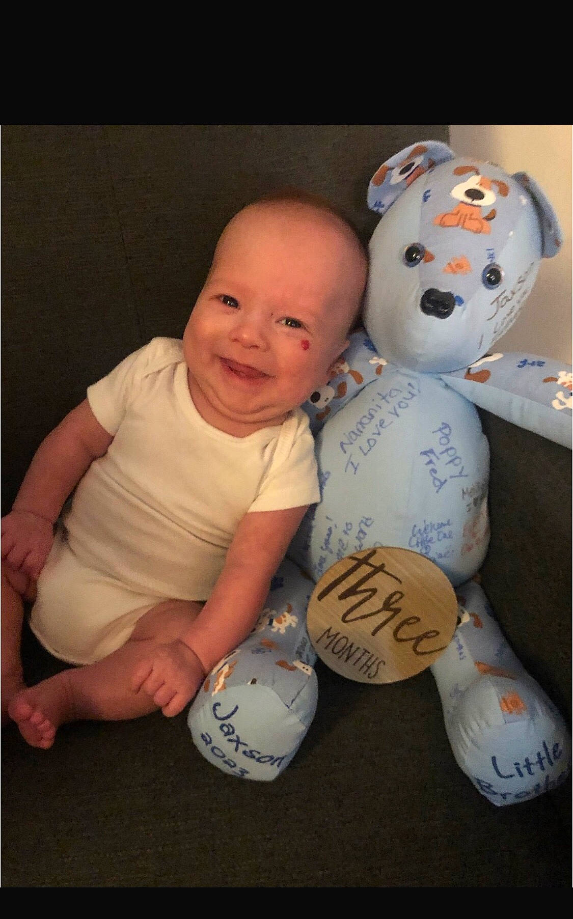 Jaxson is registered to the contest to win money with this photo: art, baby, baby_toddler_clothing, carmine, cheek, child, comfort, flash_photography, font, fun, gesture, happy, joy, person, room, sitting, smile, stuffed_toy, t_shirt, toddler