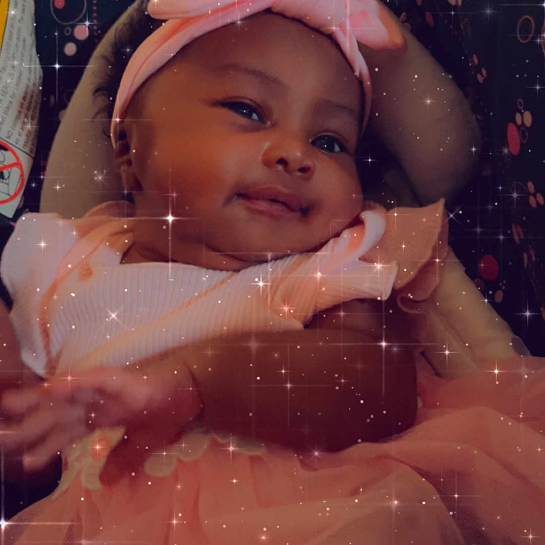 Emorie joined the competition — help win amazing prizes! baby, bodypart, bonnet, cap, clothing, costume, dress, face, finger, hand, happy, hat, head, hood, newborn, person, photography, portrait, sitting, smile