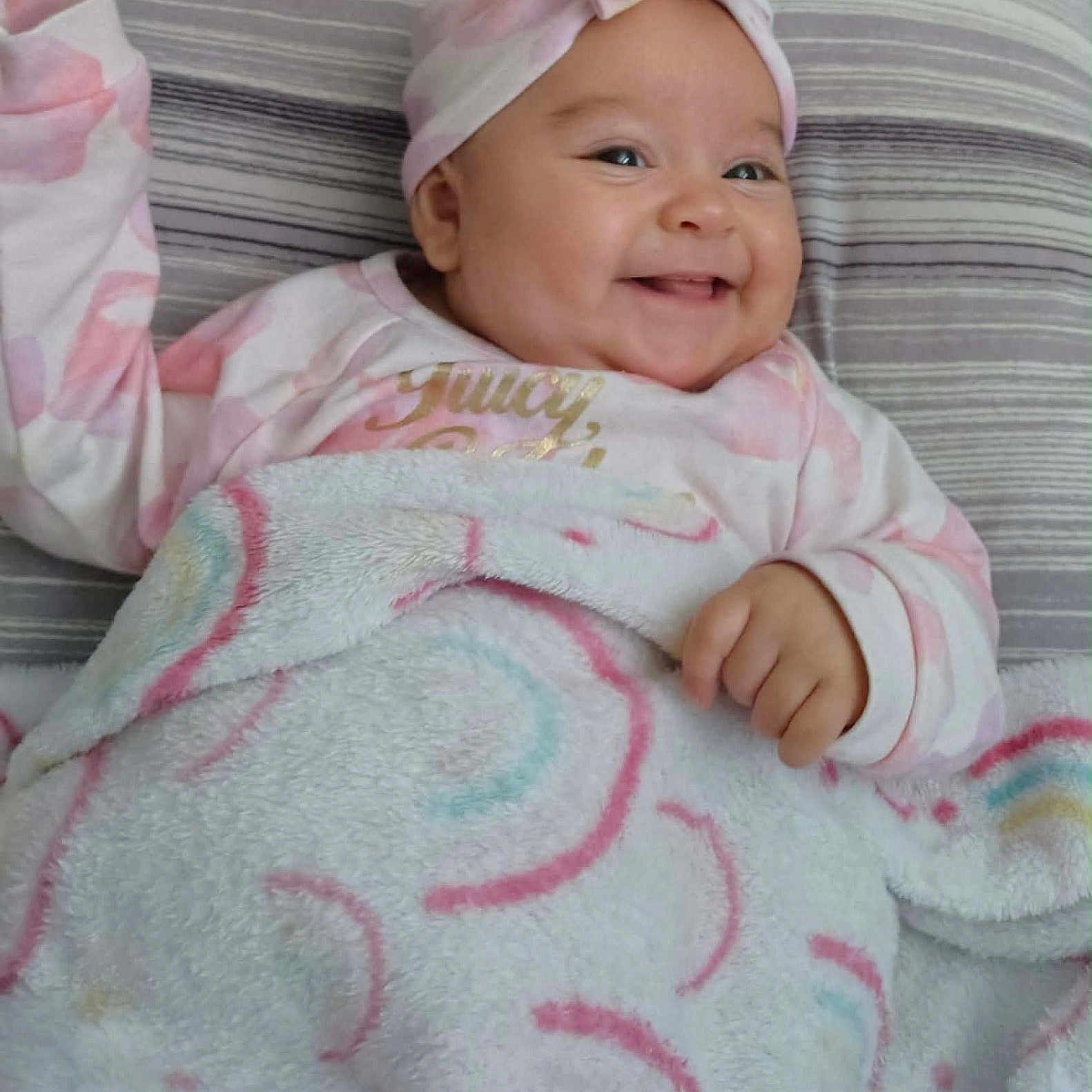 Tora joined the competition — help win amazing prizes! baby, bedspread, blanket, child, clothing, comfort, cozy, cute, expression, face, happy, headband, indoors, infant, lying_down, patterned_blanket, portrait, smiling, soft, young_child