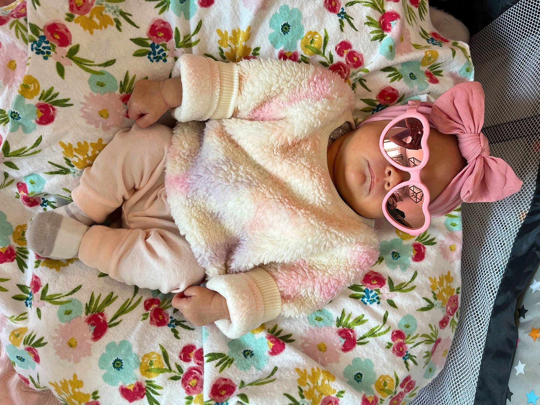 Ella is registered to the contest to win money with this photo: art, baby, baby_toddler_clothing, child, comfort, craft, creative_arts, fashion_accessory, hat, headwear, linens, pattern, peach, person, pink, sleeve, textile, toddler, white, wool