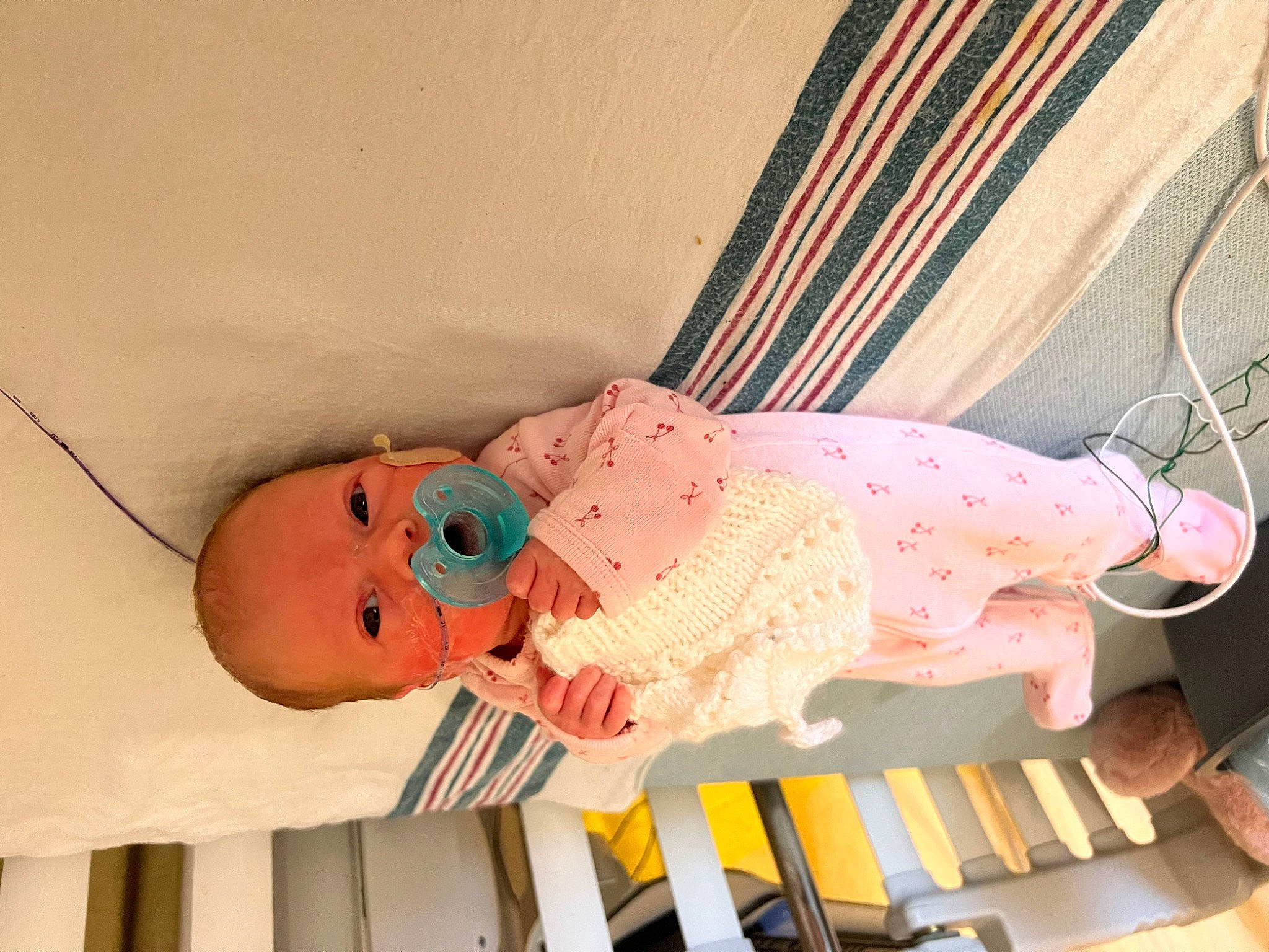 Selah is registered to the contest to win money with this photo: baby, baby_products, baby_safety, baby_toddler_clothing, baby_toys, child, comfort, curtain, infant_bed, linens, pattern, peach, person, pink, room, skin, sleeve, textile, toddler, toy