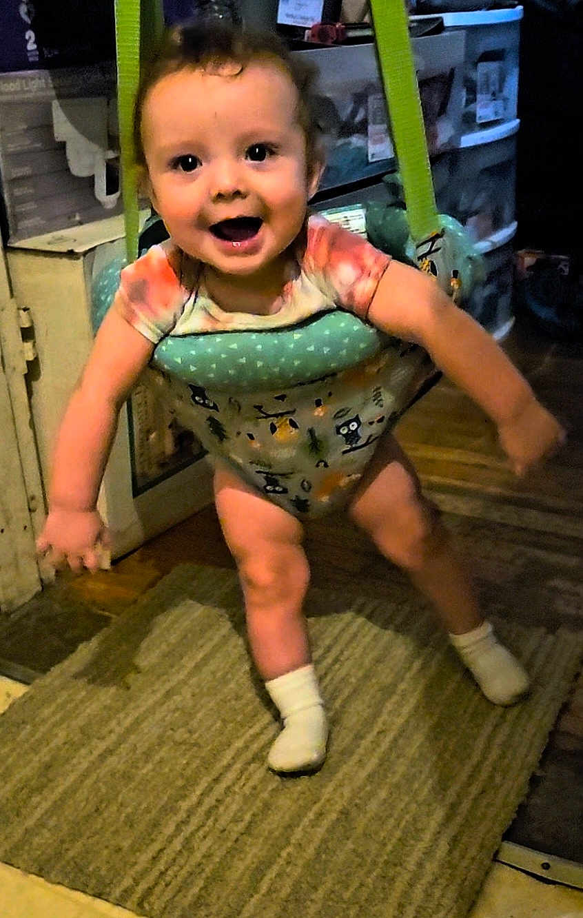 Rj Thomas is registered to the contest to win money with this photo: baby, jumper, indoor, child, smiling, socks, floor, carpet, toy, furniture, happy, person, clothing, home, play, infant, cute, expression, room, legs