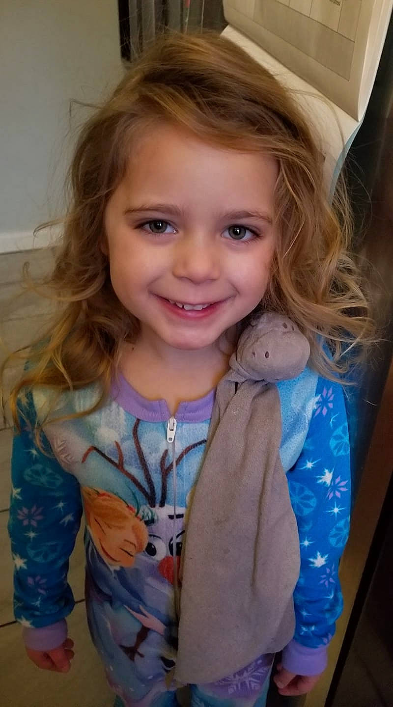 Hadley is registered to the contest to win money with this photo: blond, brown_hair, cheek, child, child_model, eye, eyebrow, face, fun, hair, hairstyle, iris, joy, lip, long_hair, outerwear, person, skin, smile, toddler