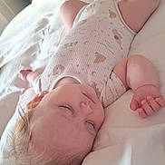 Florence-Louise is registered to the contest to win money with this photo: baby, sleeping, bed, onesie, infant, child, blanket, white_bedding, peaceful, indoors, soft_light, portrait, cute, resting, human, young_child, relaxing, cozy, furniture, home