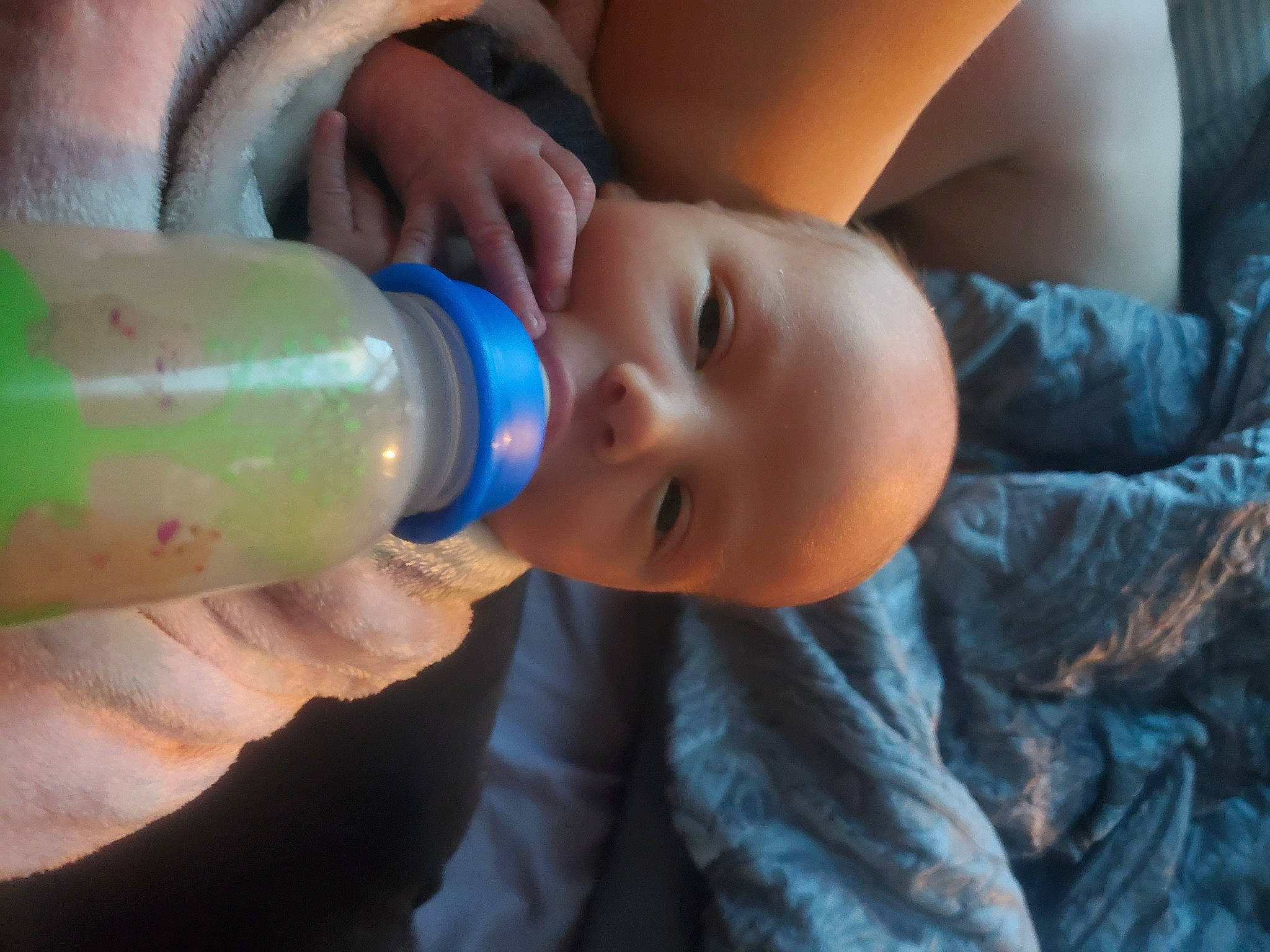 Dustin is registered to the contest to win money with this photo: baby, baby_bottle, baby_toddler_clothing, bottle, drinking, drinkware, eye, eyelash, finger, food, hand, happy, head, human_body, iris, person, plastic_bottle, skin, smile, toddler