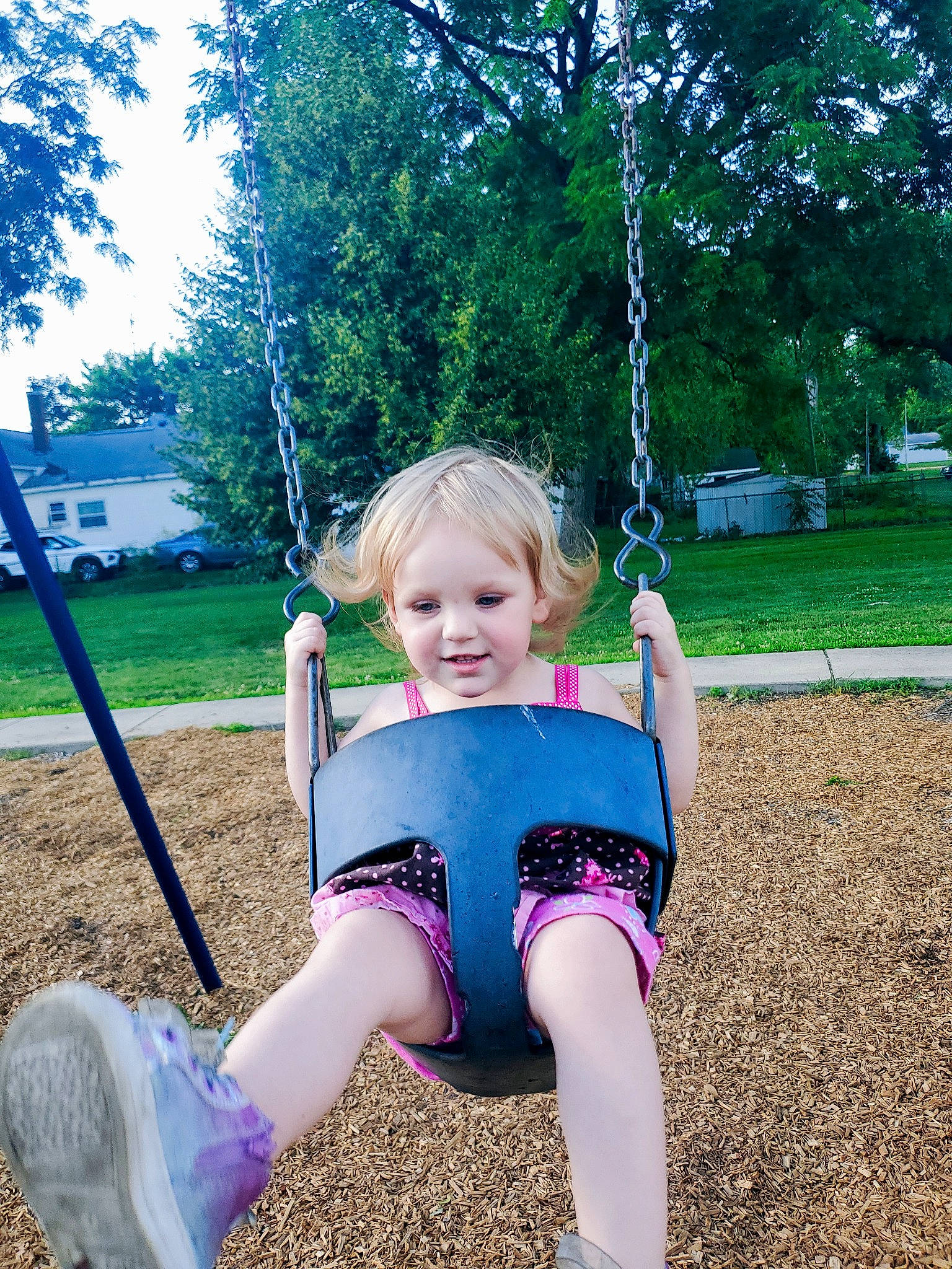 Arison is registered to the contest to win money with this photo: baby_toddler_clothing, eye, fun, grass, happy, leaf, leisure, nature, people_in_nature, person, pink, plant, playground, recreation, sleeve, smile, summer, swing, toddler, tree