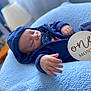 baby, blanket, blue_blanket, bokeh, closeup, cozy, hand, hooded_jacket, infant, lamp, milestone, newborn, nursery, one_month_sign, peaceful, portrait, sleeping, soft_texture, wooden_sign, zipper
