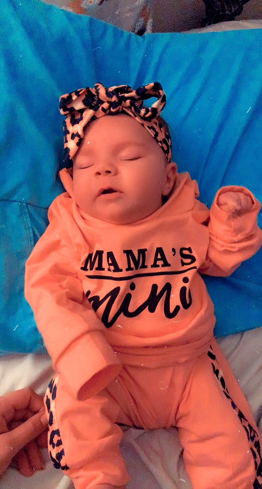 Nova is registered to the contest to win money with this photo: baby, baby_products, baby_sleeping, baby_toddler_clothing, beanie, cap, child, fashion_accessory, fun, happy, headpiece, hoodie, linens, orange, peach, person, pink, sleeve, t_shirt, textile