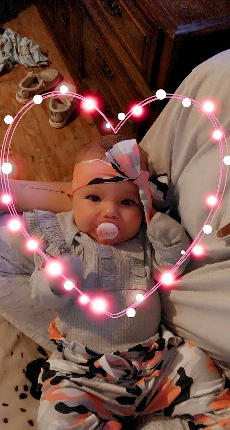 Nova is registered to the contest to win money with this photo: art, beauty, carmine, child, christmas_ornament, design, event, fictional_character, fun, gesture, happy, headwear, holiday, light, lighting, ornament, person, pink, snapshot, space