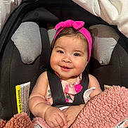 Ayla joined the competition — help win amazing prizes! baby, child, smiling, car_seat, headband, blanket, pink, cute, infant, happy, portrait, clothing, seatbelt, indoors, person, baby_girl, warm, soft, face, hands