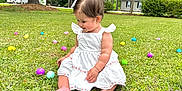 Ayla is registered to the contest to win money with this photo: toddler, child, grass, easter_eggs, white_dress, smiling, outdoor, nature, trees, suburban, house, greenery, cute, happy, barefoot, spring, daytime, playful, colorful, baby