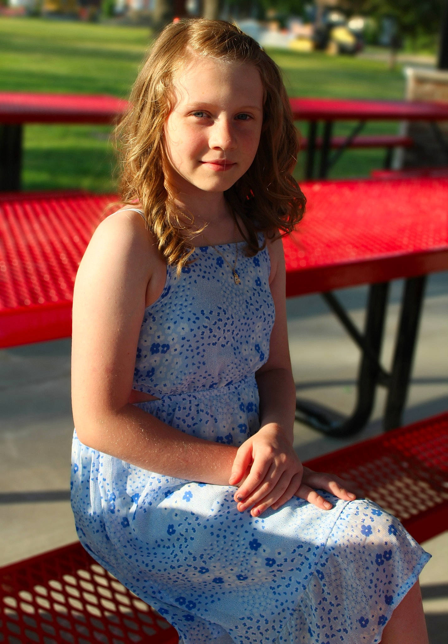 Evelyn is registered to the contest to win money with this photo: beauty, child, electric_blue, facial_expression, fun, grass, hair, hairstyle, happy, head, human_leg, joy, knee, leisure, long_hair, person, plant, recreation, smile, thigh