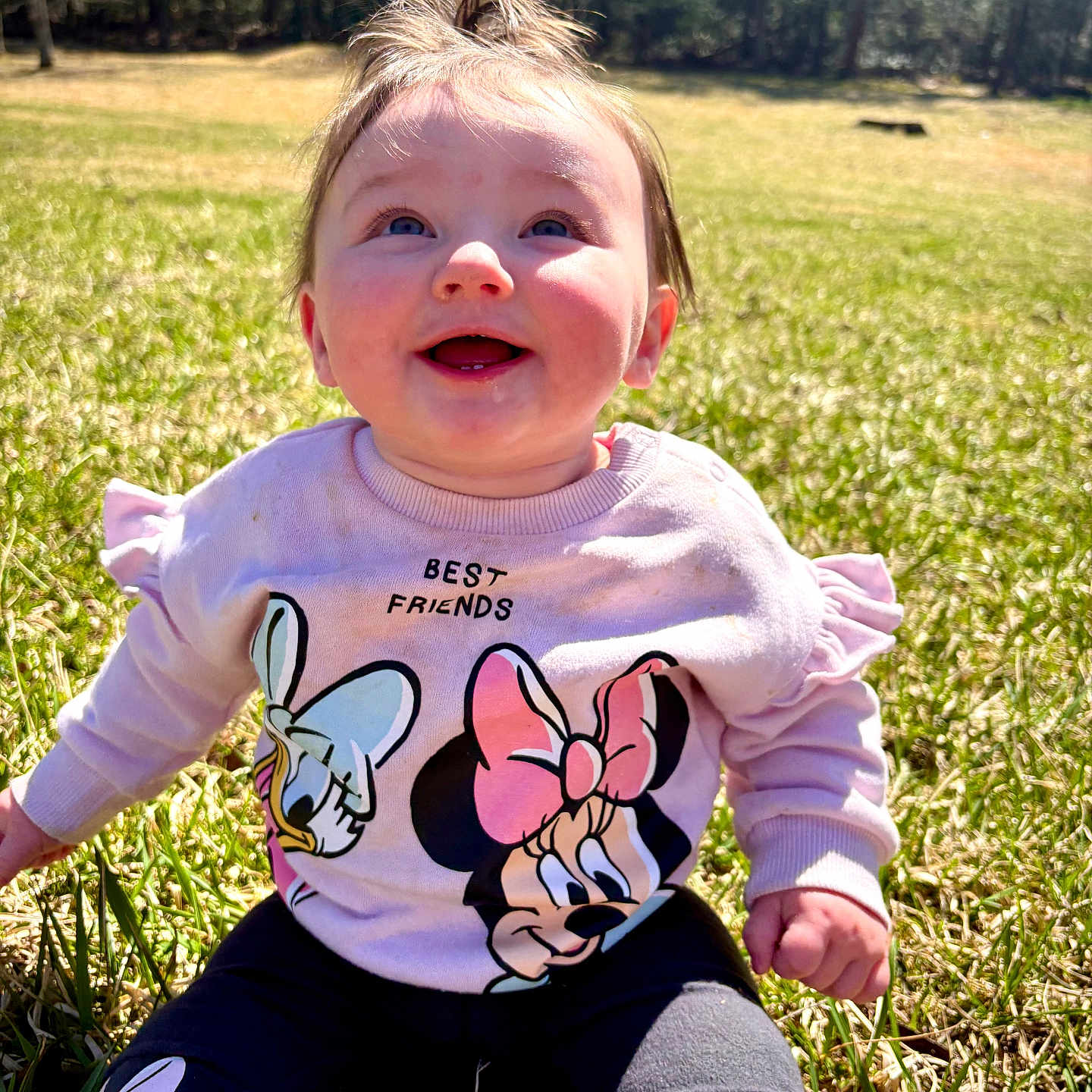 Renezemae is registered to the contest to win money with this photo: baby, clothing, face, footwear, grass, happy, head, nature, outdoors, pants, park, person, photography, plant, portrait, shirt, sitting, t_shirt, tree, vegetation