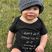 Jimmy joined the competition — help win amazing prizes! baby, beanie, black_clothing, casual, cheeks, child, cute, expression, eyes, face, grass, hat, infant, nature, outdoor, photography, portrait, serious, sitting, text_on_clothing