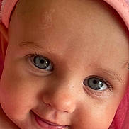 Mabel joined the competition — help win amazing prizes! baby, close_up, face, smiling, blue_eyes, drool, pink_towel, skin, infant, cute, child, portrait, soft_texture, happy, cheeks, head, eyelashes, innocence, warmth, toddler