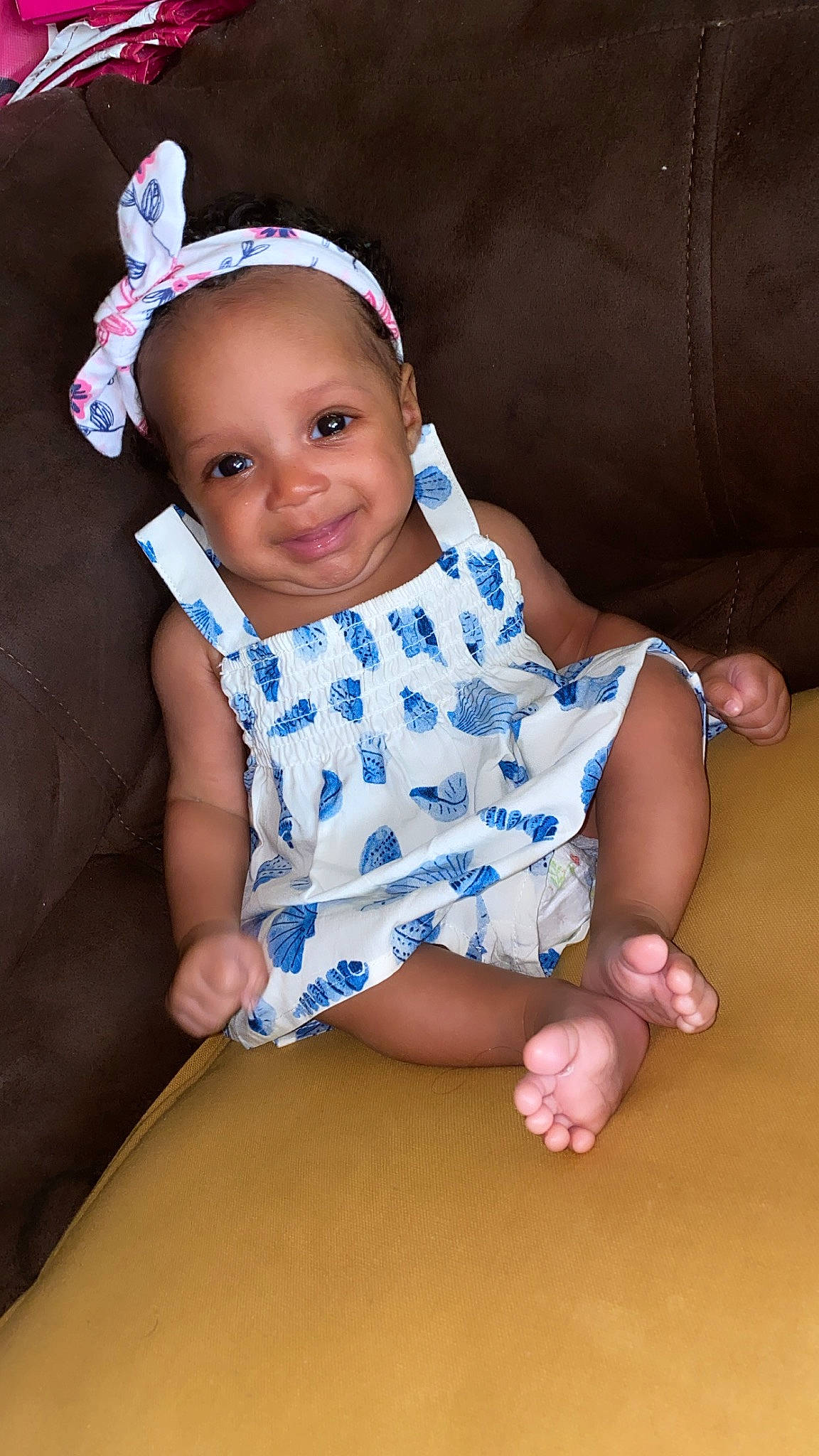 Brielle is registered to the contest to win money with this photo: baby, baby_toddler_clothing, child, dress, electric_blue, face, flash_photography, foot, fun, happy, head, headgear, human_leg, joy, pattern, person, pink, skin, sleeve, smile