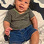 Kohlson is registered to the contest to win money with this photo: baby, child, smiling, sitting, clothing, shorts, tshirt, shoes, indoor, bed, pillow, pattern, cute, happy, face, person, infant, skin, head, earrings