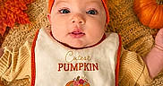 Maddie joined the competition — help win amazing prizes! baby, infant, bib, pumpkin, headband, orange, fall_leaves, autumn, knitted_blanket, cute, portrait, child, seasonal, festive, smiling, closeup, cozy, holiday, pumpkin_patch, happy