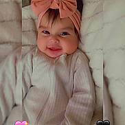 Daleyza joined the competition — help win amazing prizes! baby, infant, smiling, headband, bow, cute, cozy, blanket, soft, fuzzy, clothing, portrait, child, happy, indoors, face, person, heart_emoji, pink, black