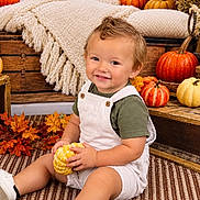 Kingston joined the competition — help win amazing prizes! child, toddler, smiling, portrait, autumn, fall, pumpkin, gourd, leaves, outdoor, seasonal, cozy, blanket, wooden_crate, rustic, sitting, overalls, green_shirt, white_shoes, photography