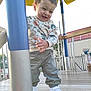 Ayden participe au concours pour gagner de l'argent avec cette photo : toddler, child, playground, outdoor, smiling, happy, sweater, pants, sneakers, pole, wooden_floor, yellow_canopy, metal_pole, fence, daylight, person, playing, casual_clothing, cute, fun
