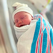 Sophia is registered to the contest to win money with this photo: newborn, baby, sleeping, blanket, hospital, hat, infant, swaddled, cute, portrait, child, peaceful, soft_focus, closeup, resting, person, newborn_baby, wrapped, indoors, headwear