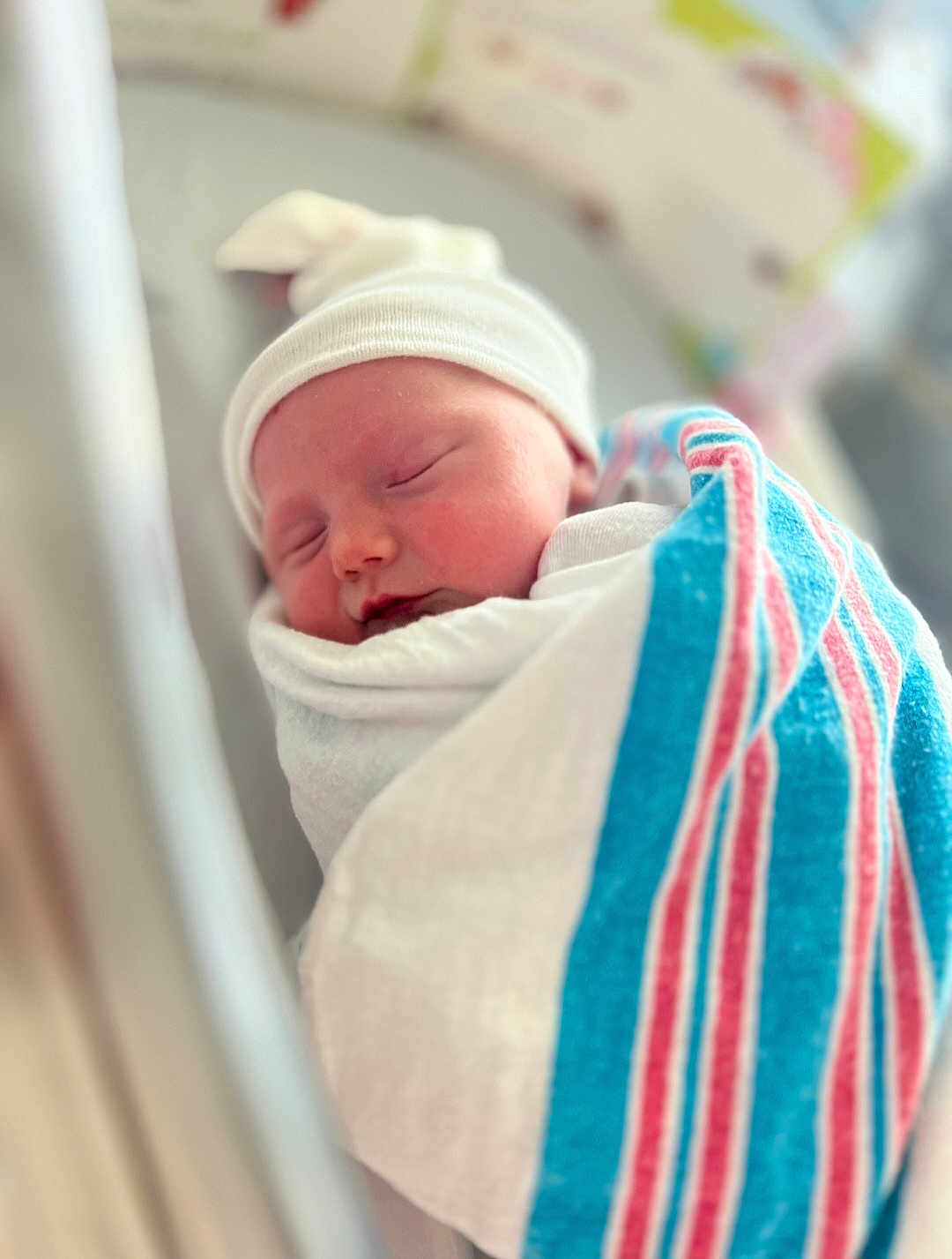 Sophia is registered to the contest to win money with this photo: newborn, baby, sleeping, blanket, hospital, hat, infant, swaddled, cute, portrait, child, peaceful, soft_focus, closeup, resting, person, newborn_baby, wrapped, indoors, headwear