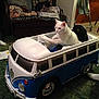 Coolwhip joined the competition — help win amazing prizes! cat, toy_car, indoor, carpet, furniture, couch, blanket, human_legs, white_cat, steering_wheel, toy_vehicle, green_carpet, wooden_chair, floor, living_room, pet, animal, playful, domestic, cute