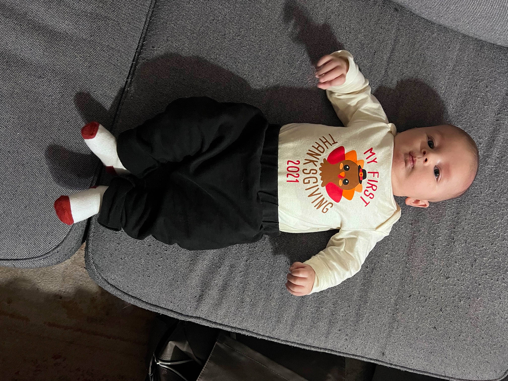 Jason is registered to the contest to win money with this photo: baby, baby_products, baby_safety, baby_toddler_clothing, carmine, child, comfort, hand, hat, knee, leg, outdoor_shoe, pattern, person, sitting, sleeve, sock, toddler, walking_shoe, wood