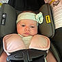 baby, infant, car_seat, headband, bow, safety_harness, pink, green, child, seatbelt, straps, infant_car_seat, closeup, cute, young_child, indoor, expressionless, child_safety, padded, baby_clothing