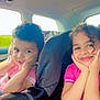 Lina a rejoint le concours — aidez-le/la à gagner de superbes lots ! child, children, car_seat, car_interior, pink_shirt, smile, happy, curly_hair, seatbelt, window, daylight, cute, portrait, two_people, sitting, playful, hands_on_face, young, travel, family