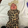 baby, infant, leopard_print, onesie, headband, bow, blanket, white, sleepwear, cute, lying_down, face, expression, newborn, child, clothing, soft, indoor, person, portrait