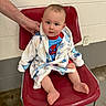baby, child, infant, portrait, sitting, chair, red_chair, robe, bathrobe, spiderman, superhero, clothing, blue, red, smiling, indoors, wall, adult_hand, bare_feet, photography