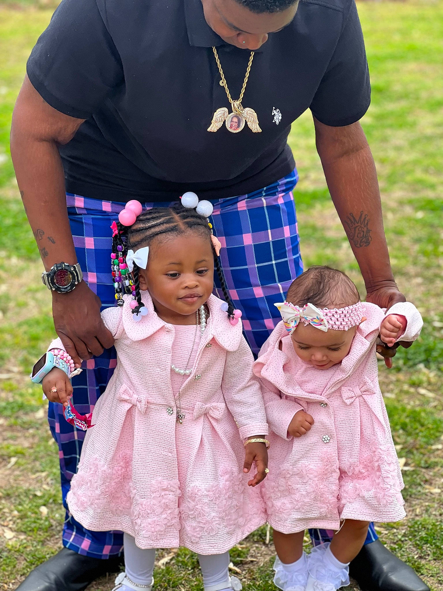 Gianna is registered to the contest to win money with this photo: baby_toddler_clothing, child, clothing, event, fashion, fun, gesture, grass, happy, pattern, people_in_nature, person, pink, plaid, purple, shoe, sleeve, summer, tartan, textile