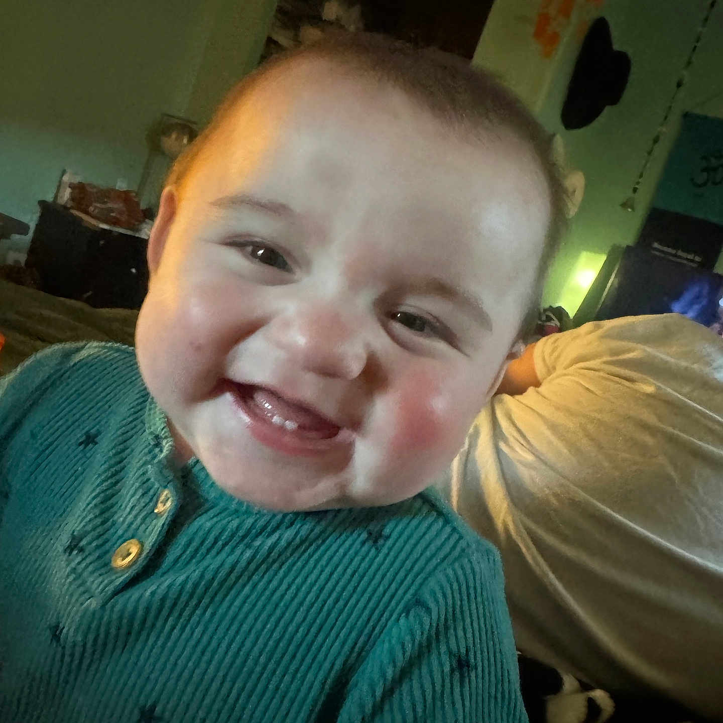 Stetson joined the competition — help win amazing prizes! adult_in_background, baby, bedroom, blanket, candid, cheeks, closeup, eyes, face, happy, indoor, infant, mouth, portrait, ribbed_sweater, rosy_cheeks, smiling, teal_sweater, teeth, toddler