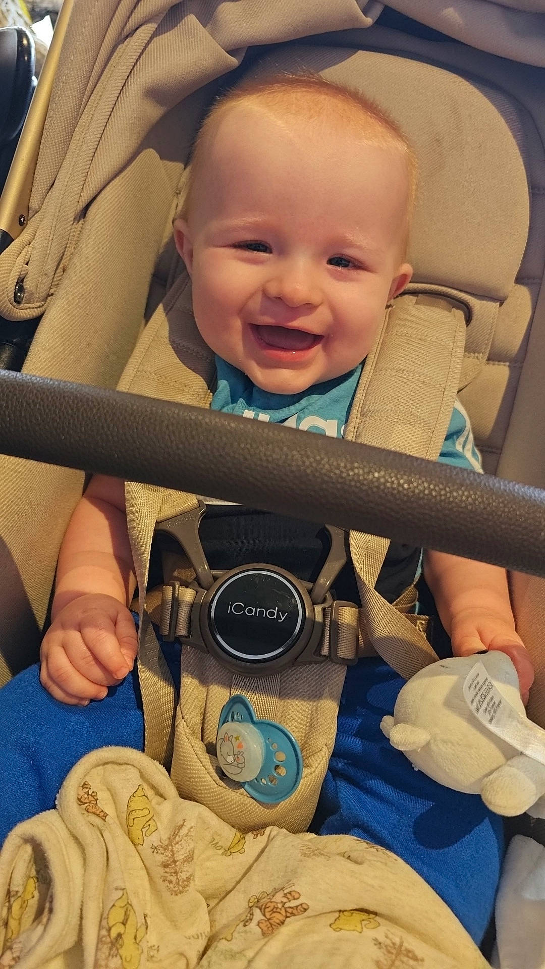 Hudson is registered to the contest to win money with this photo: accessories, baby, clothing, coat, cushion, electronics, face, happy, head, homedecor, jacket, laughing, pants, person, photography, portrait, smile, strap, t_shirt, transportation