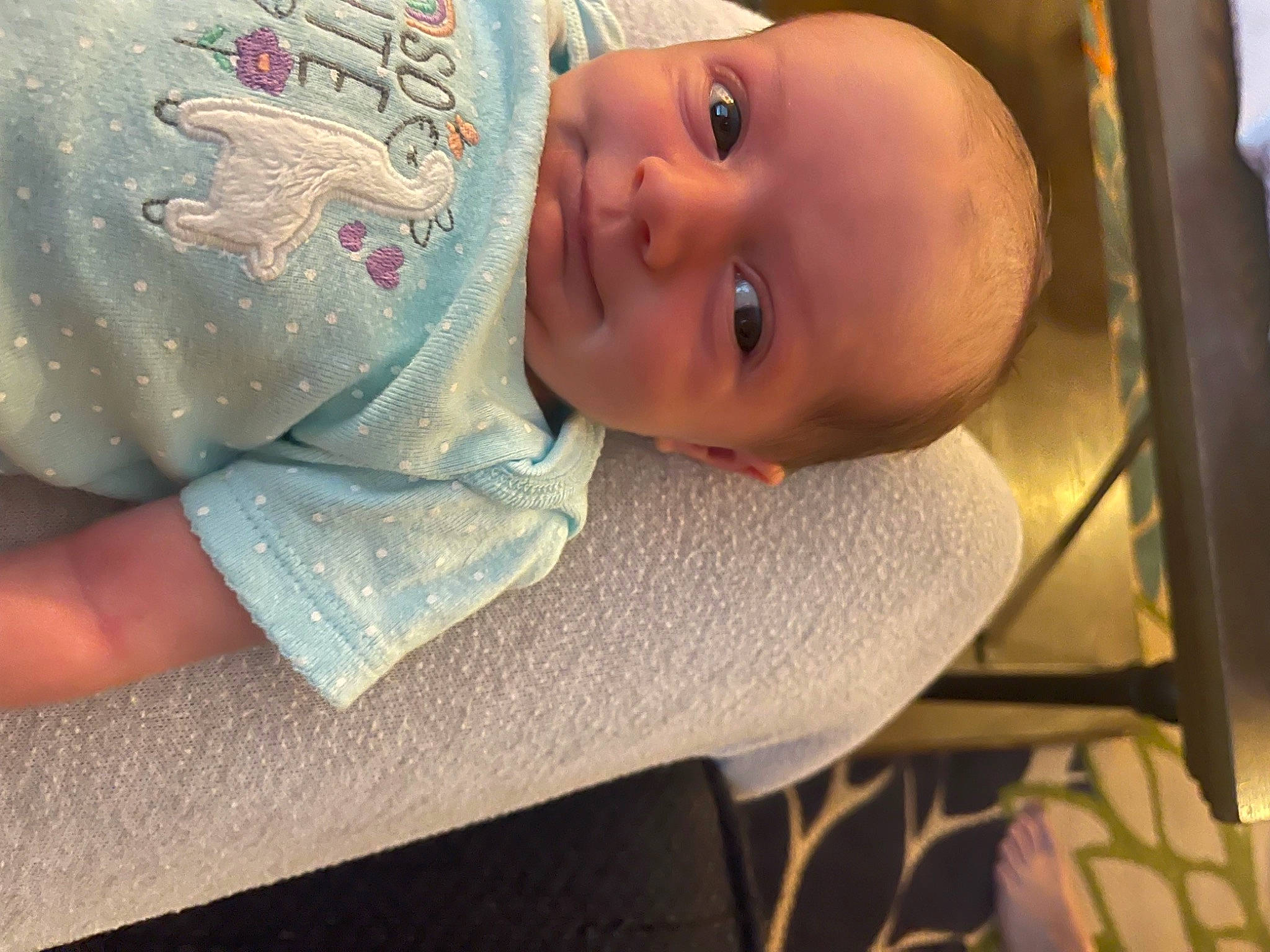 Bexley is registered to the contest to win money with this photo: arm, baby, baby_products, baby_safety, baby_toddler_clothing, cheek, child, comfort, cradle, eyelash, finger, infant_bed, linens, mouth, pattern, person, room, skin, sleeve, smile