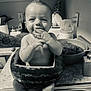 Henry is registered to the contest to win money with this photo: baby, watermelon, kitchen, countertop, tattoo, sink, smiling, hands, fruit, child, playful, monochrome, cute, person, supporting_arm, food, domestic, expression, sitting, innocence