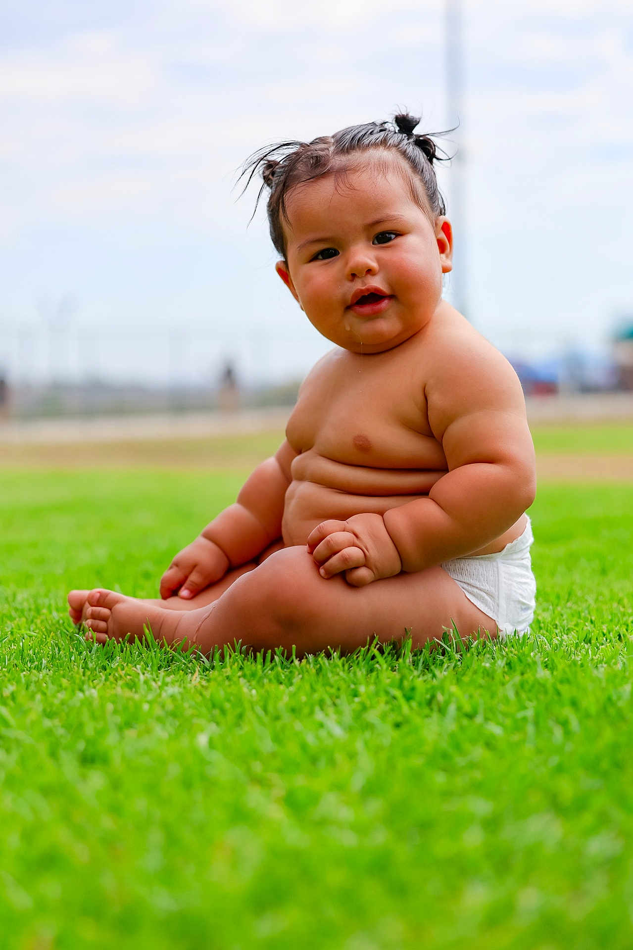 Rudy is registered to the contest to win money with this photo: baby, child, grass, outdoor, diaper, cute, drool, pigtails, skin, chubby, sitting, portrait, nature, daylight, greenery, infant, happy, young, person, funny