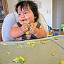 Rudy is registered to the contest to win money with this photo: baby, high_chair, messy, food, avocado, face, hands, happy, indoor, child, hair, smile, tray, furniture, playing, candid, cute, infant, expression, eating