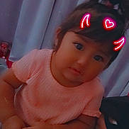 Amara is registered to the contest to win money with this photo: toddler, child, girl, pink_shirt, curtains, indoors, face, hands, sitting, neon_filter, devil_horns, heart, expression, person, cute, young_child, portrait, hair_tie, skin, casual_clothing