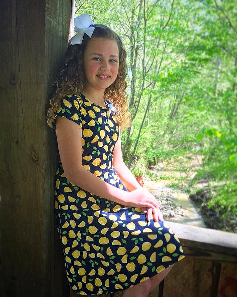 Avelina is registered to the contest to win money with this photo: clothing, day_dress, design, dress, fawn, joy, long_hair, pattern, person, photo_shoot, photography, polka_dot, smile, yellow