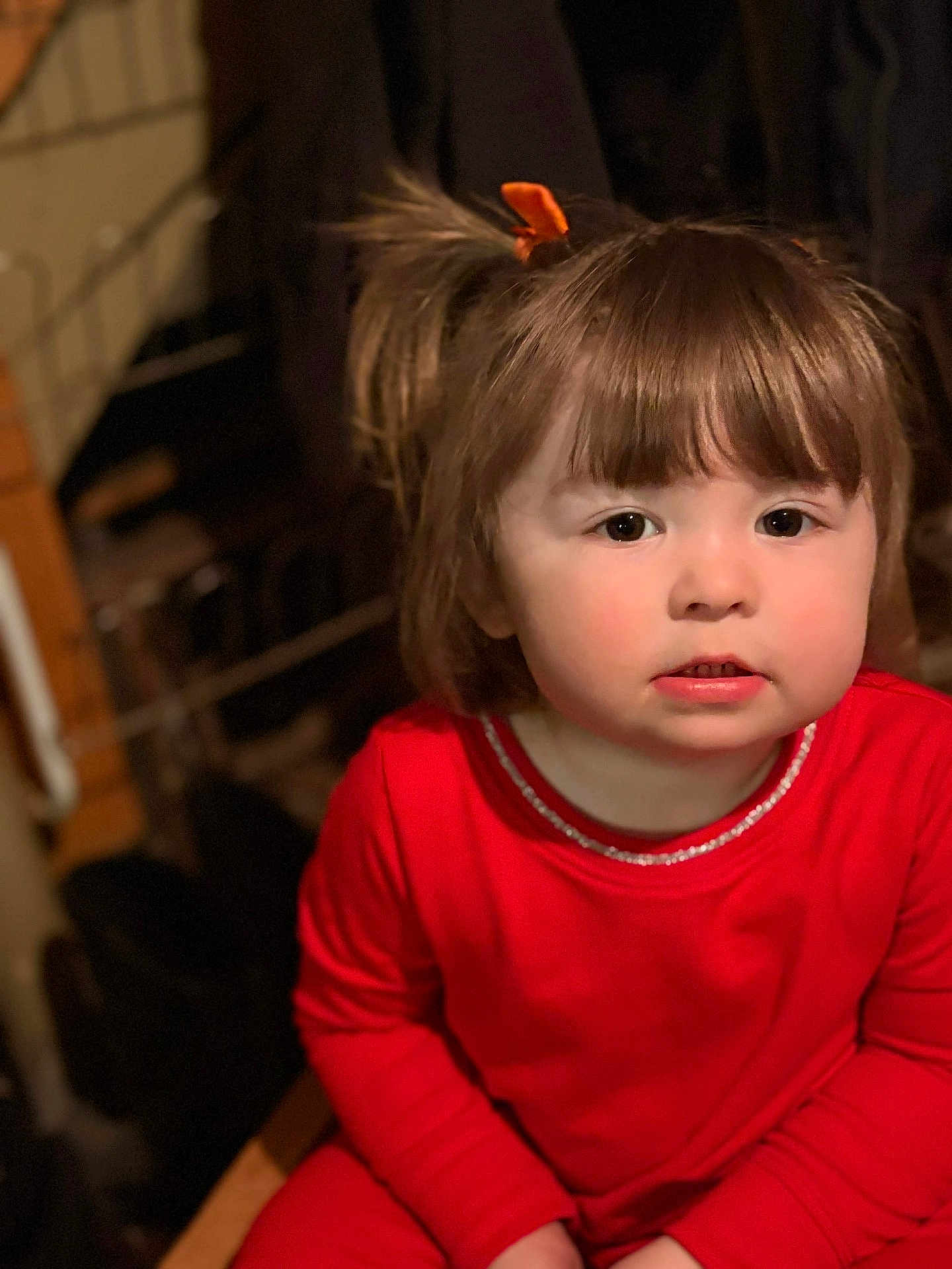 Kinzel joined the competition — help win amazing prizes! toddler, child, girl, red_clothing, indoors, portrait, face, brown_hair, pigtails, cute, young_child, seated, looking_at_camera, warm_lighting, casual, expression, innocent, person, close_up, soft_background