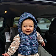 Railey participe au concours pour gagner de l'argent avec cette photo : baby, child, car_seat, hoodie, floral_pattern, smile, blue_hood, pink_zipper, seated, clothing, infant, cute, indoors, window, rain_drops, car_interior, person, young_child, happy, portrait