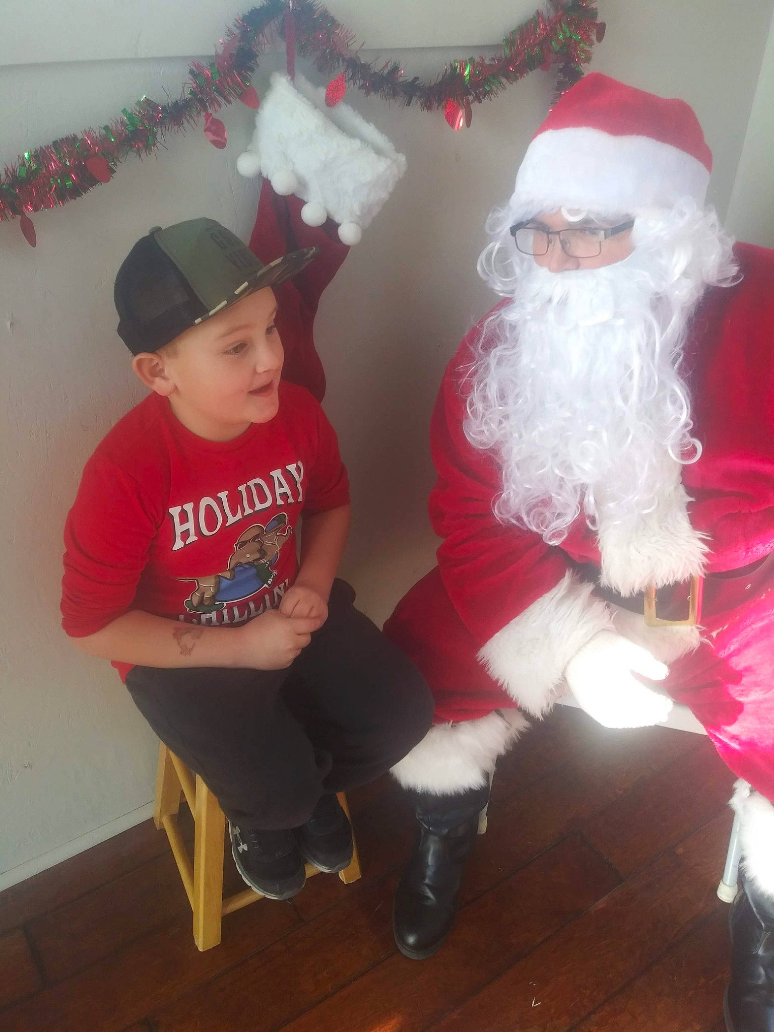 Theodore Verdugo Jr joined the competition — help win amazing prizes! baseball_cap, beard, cap, christmas, christmas_eve, costume_hat, event, fictional_character, fun, happy, hat, headwear, holiday, human_body, lap, leg, person, red, santa_claus, sleeve