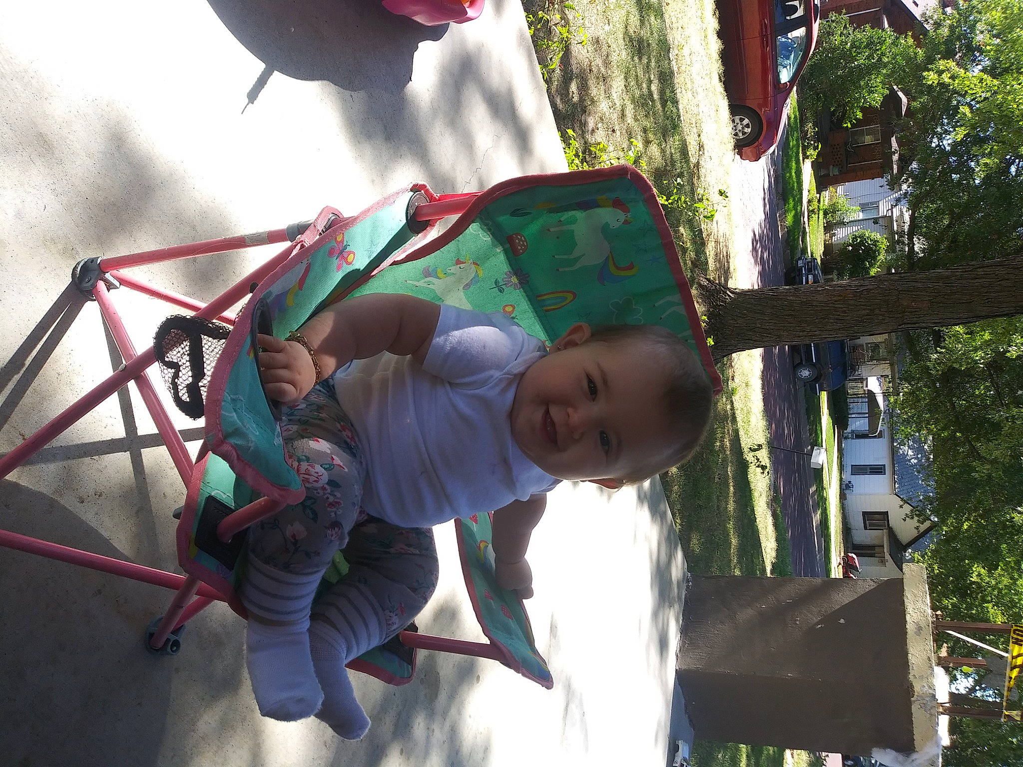 Gabriella is registered to the contest to win money with this photo: baby, child, city, fun, grass, green, happy, leisure, outdoor_play_equipment, person, plant, play, playground, recreation, smile, swing, t_shirt, toddler, tree, vacation