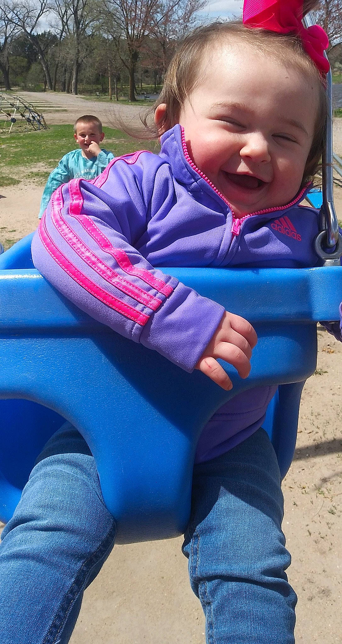 Gabriella is registered to the contest to win money with this photo: azure, baby, baby_toddler_clothing, black, blue, comfort, electric_blue, grass, green, happy, leisure, people, person, photograph, purple, recreation, skin, smile, toddler, tree