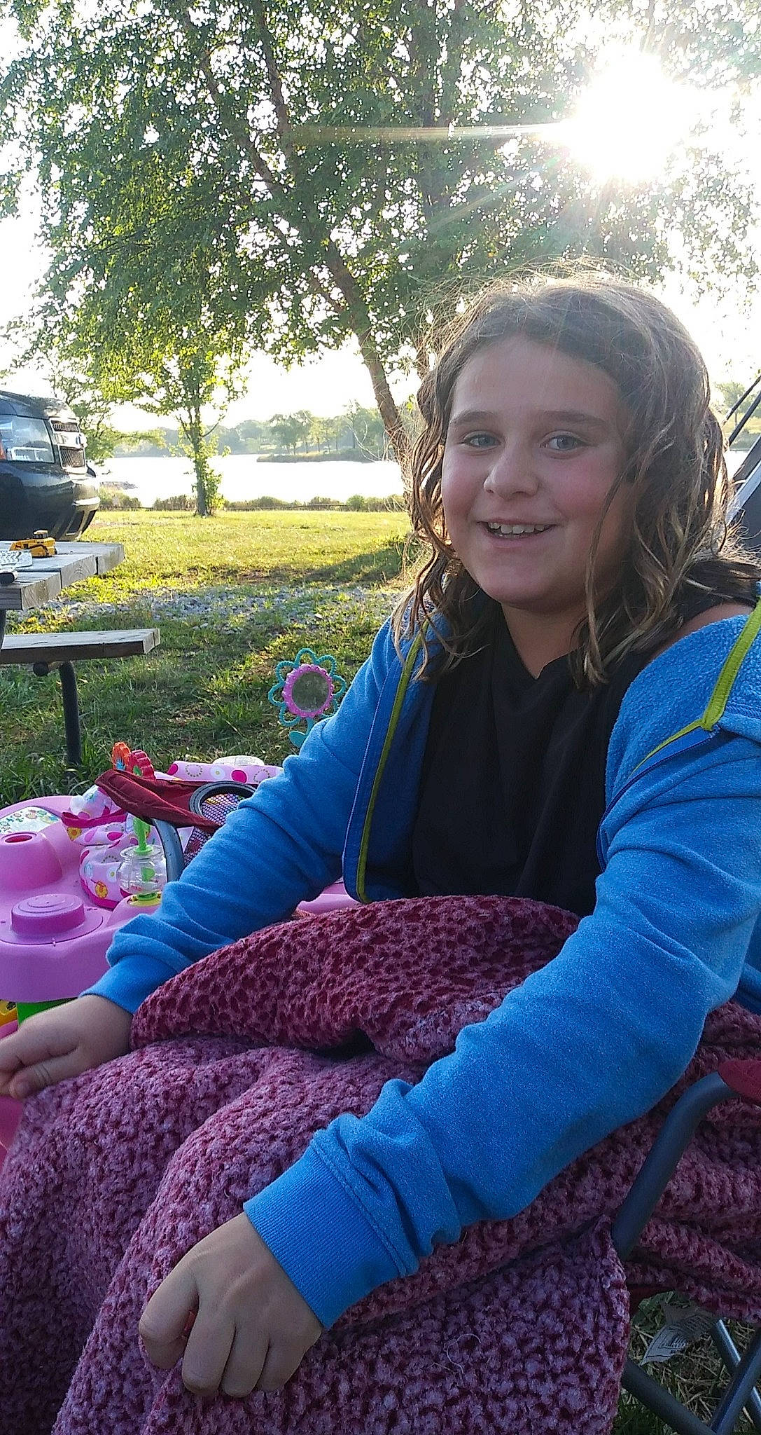 Kiley is registered to the contest to win money with this photo: beauty, botany, child, daytime, electric_blue, facial_expression, fun, grass, happy, joy, lap, leaf, leisure, long_hair, nature, person, plant, recreation, smile, summer